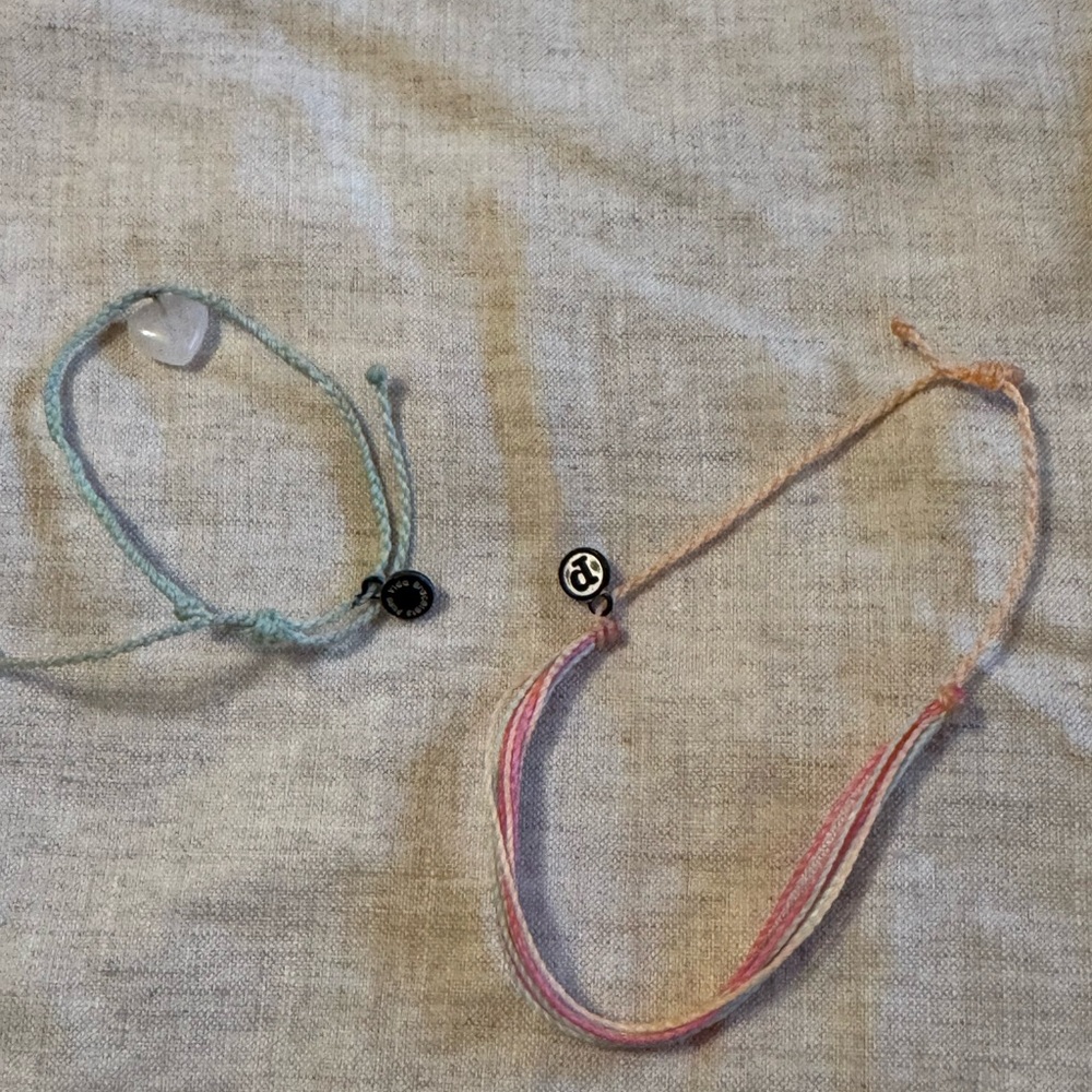 Pure Vida two bracelets. New. Light green with charm and a pink medley.